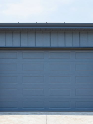 Wide exterior shot of a modern home with a newly installed, clean garage door, crisp industrial photography, bright natural daylight, clean high-contrast blue and steel tones, sharp focus, 35mm lens, low horizon.