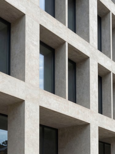 Elegant architectural close-up of a modern French government building facade with clean geometric concrete lines and soft daylight, 35mm photography
