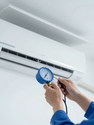 Close-up of a technician's hands using a digital pressure gauge on a pristine indoor air conditioning unit, bright daylight, cool blue and white tones
