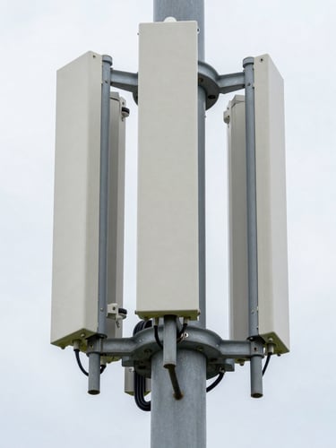 Tight technical close-up of antenna array hardware and mounting brackets on a macro cell tower, overcast daylight, Southeast United States, crisp equipment detail, no people, operational infrastructure in daylight