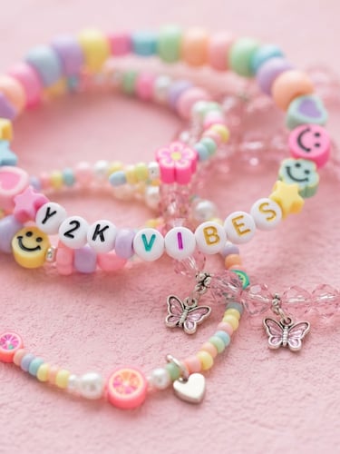 Macro product close-up of colorful pastel Y2K beads and pink crystal bracelets on a soft pink background, bright studio lighting, 35mm