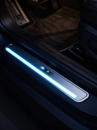 Close-up of a premium LED car door sill glowing in a dark cabin, magnetic trigger setup visible, moody automotive photography, 35mm lens