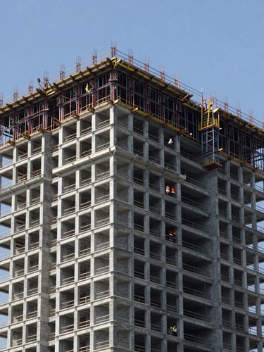 Wide environmental architectural photography of a modern high-rise construction site in Rio de Janeiro, clean steel structures, workers in proper safety gear under crisp daylight.
