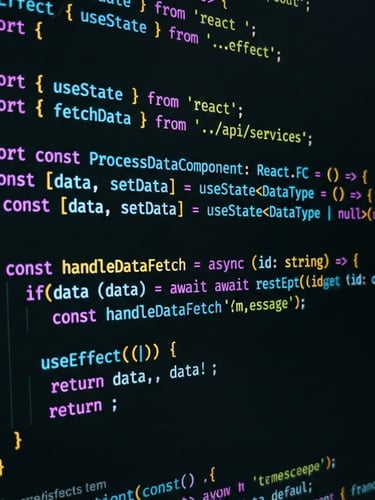 Macro close-up of clean, well-documented code on a modern monitor, low-key moody studio lighting with sharp neon terminal accents, high-contrast details