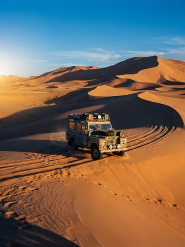 Wide cinematic shot of a single vintage 4x4 vehicle driving across massive golden sand dunes in the Western Desert, long shadows, harsh late afternoon sun, extreme scale.