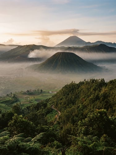 Wide environmental landscape of misty Indonesian volcanic highlands at golden hour, lush green valleys, 35mm lens editorial travel photography