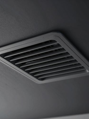 Extreme close-up of a sleek, flush-mounted architectural AC vent integrated seamlessly into a dark graphite ceiling, subtle cool air refraction visible.