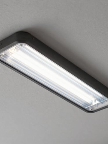 Close-up of a premium, flush-mounted linear diffuser integrated into a clean plaster ceiling, showing subtle cool-air refraction effects.