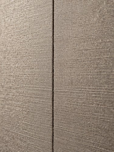 Close-up of fabric wall finish and track join