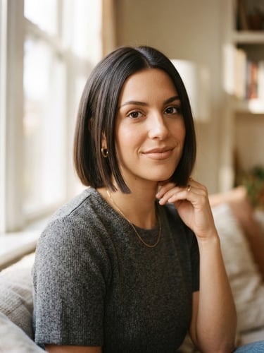 Elegant portrait of a woman with a structured modern bob, soft natural window light, warm nude tones, shallow depth of field, 35mm