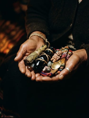 Close-up of hands holding sacred Andean ceremonial objects, warm candlelight, deep shadows, rich gold and obsidian tones, mystical editorial photography