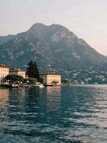 Elegant editorial photography of Lake Maggiore shoreline at sunrise, soft natural lakeside light, deep teal water, calm atmosphere, medium format