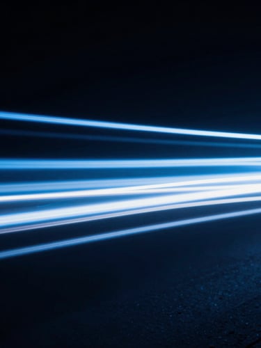 Abstract light trails representing data movement, high contrast, cool blue tones, dark background