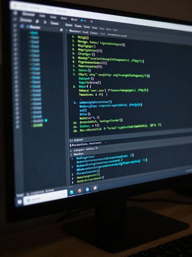 Close-up of a terminal window on a dark monitor, Node.js server log output scrolling — green and cyan text on near-black background, screen glow casting cool light on the surrounding desk surface, tight crop showing only the screen and immediate edge of the keyboard