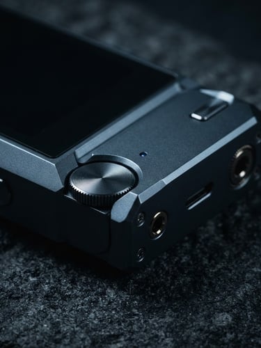 Dark minimalist product photography, macro close-up of a sleek metallic digital device on a dark textured surface, sharp geometric lines, deep night blue studio lighting, 35mm