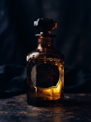 Dramatic low-key studio shot of a dark amber glass perfume bottle silhouette, golden liquid glistening inside, warm directional lighting, deep shadows, 35mm photography