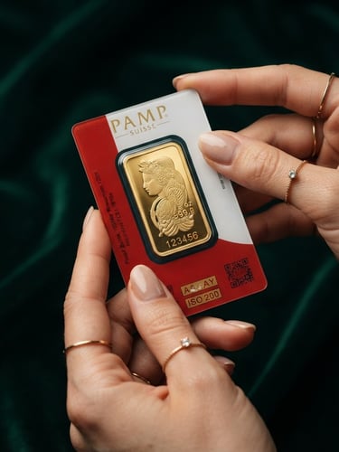 Premium product photography of certified physical gold bar with assay certificate, held gently by elegant hands, soft directional studio lighting, deep emerald background, macro lens