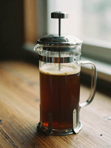 A glass French press filled with dark coffee, a thick layer of crema on top, sitting on a rustic wooden table, warm window light, 35mm film