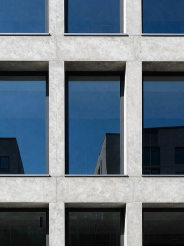 A sharp architectural perspective of a modern minimalist concrete and steel building facade, cool daylight, stark shadows, royal blue ambient light reflection, ultra-sharp focus