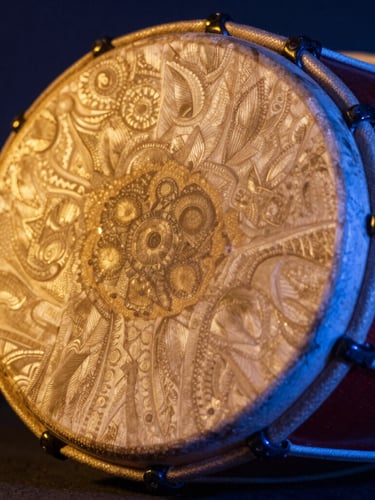 Close-up of a carved mridangam drum head, dramatic golden-hour highlights, neon blue ambient rim lighting, 35mm editorial
