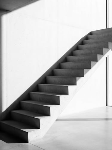 Minimalist architectural photography of clean concrete stairs casting sharp geometric shadows under bright daylight, ultra-clean composition, 50mm