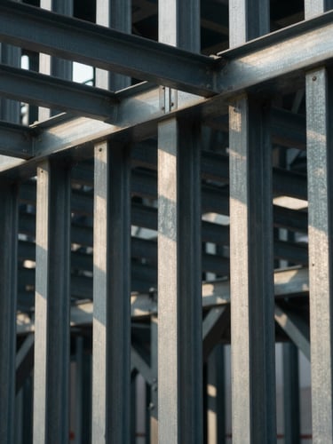 Architectural close-up of structural framing and steel columns, dramatic shadows, cool diffuse daylight.