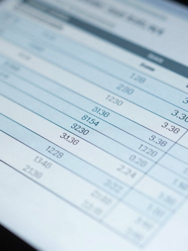 Macro close-up of a digital screen showing a technical calibration report, cool daylight, sterile blue tones, sharp focus on data columns.