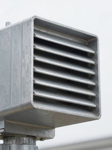 Crisp industrial close-up of a heavy-duty aluminum louvred vent actuator, bright overcast daylight, cool metallic tones, sharp focus, 35mm
