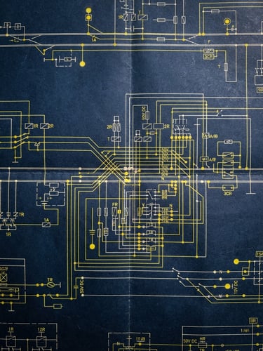 A close-up technical schematic of railway track signaling circuits, high-contrast blueprint lines on a dark blue background.