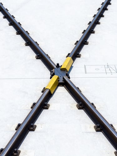Technical blueprint schematic of a railway turnout assembly, sharp lines, high contrast navy and yellow tones