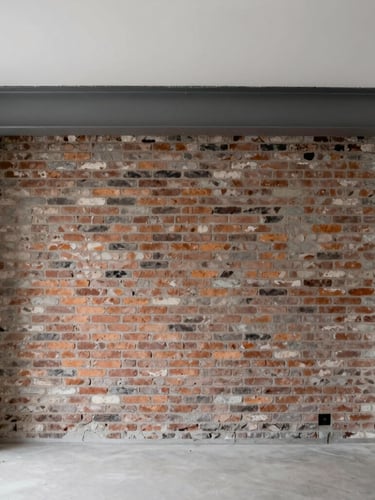 Straight-on architectural photo of a raw mid-renovation Belgian townhouse interior, exposed brick wall, structural steel beam, soft overcast daylight, sharp focus.