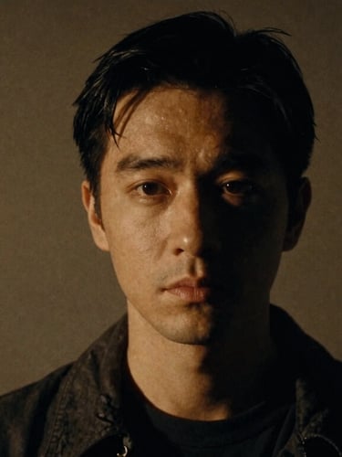Dramatic portrait of a character actor in shadows, warm spotlight highlight, cinematic 35mm film