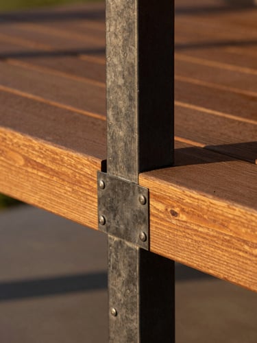 Close-up architectural shot of flawless steel-to-wood joinery on a modern veranda, rich cedar wood meeting dark charcoal steel, warm late-afternoon golden hour sunlight, sharp focus on structural connections.