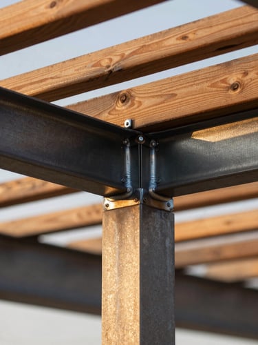 Close-up macro shot of flawless steel-to-wood joinery on a pergola structure, showcasing clean welds, dark charcoal powder coating, and premium cedar wood slats under warm golden hour light.