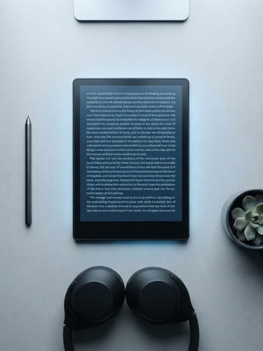 Overhead flatlay of a modern e-reader showing crisp typography on a dark screen, minimalist digital workspace, cool blue backlighting, sharp focus