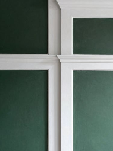 Close-up of a perfectly painted interior wall junction, crisp white paint, minimalist trim, soft natural side lighting, architectural detail