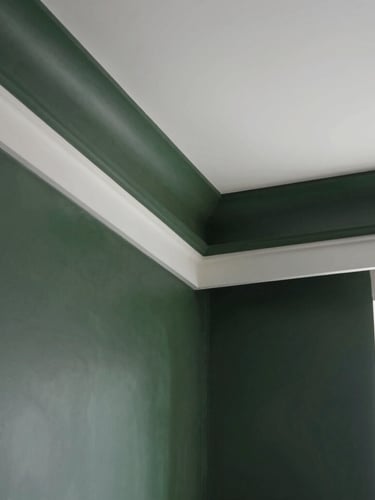 Crisp interior remodeling detail showing a flawless drywall transition and clean paint lines in a modern high-end home, natural light, 35mm.