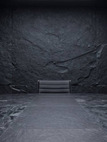 Subtle architectural detail of a modern executive boardroom, dark slate panels, low-key focused studio lighting, deep shadows, minimalist editorial photography