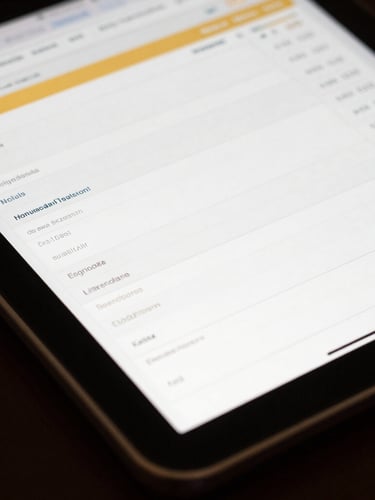 Tight macro shot of a tablet displaying a clean, high-contrast financial spreadsheet with gold accents, natural side-lighting, dark controlled shadows.