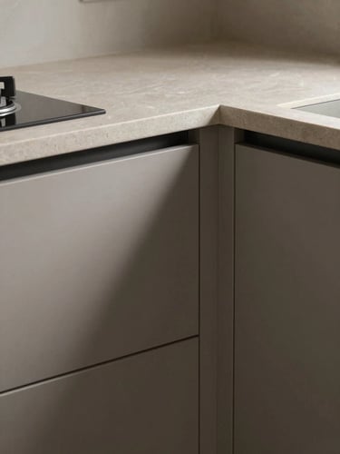 Tight close-up of a modular kitchen corner under diffused north-facing light, matte stone countertop and lacquered cabinet face visible, sharp material texture, no people or props