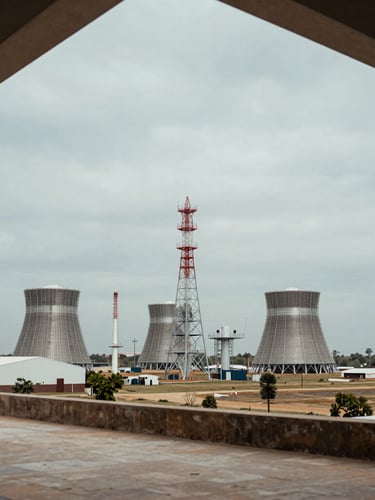 Wide panoramic shot of a modern energy infrastructure site in Mexico under an overcast sky, architectural framing, muted earth tones