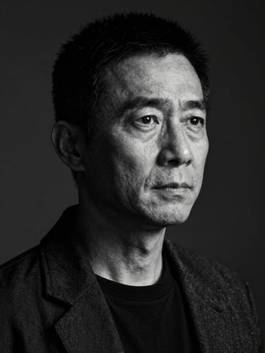 High-contrast black and white portrait of director Marcus Chen looking off-camera, dramatic chiaroscuro lighting, dark studio background