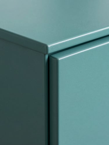 Extreme macro close-up of a flawless, matte teal cabinet door edge, highlighting the zero-texture factory-grade finish under bright, clinical white light.