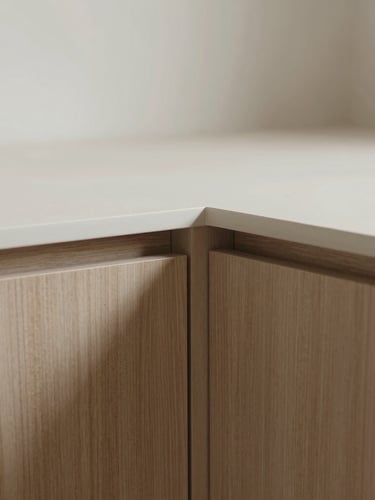 Close-up of perfectly aligned cabinet joints, soft natural daylight casting subtle shadows, warm oak veneer and matte MDF, minimalist architectural photography, 35mm lens.