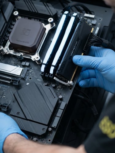Close-up of a technician's hands carefully installing a high-performance RAM stick into a clean motherboard, bright cool LED indicators, sharp focus, 50mm.