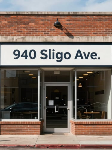 Straight-on eye-level architectural photograph of the clean brick storefront at 940 Sligo Ave under bright natural daylight, clear municipal signage, no people.