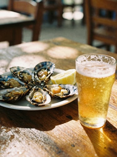 A close-up lifestyle shot of fresh seafood and a cold draft beer on a rustic wooden table at a local neighborhood boteco, dappled sunlight filtering through, warm 35mm film aesthetic.