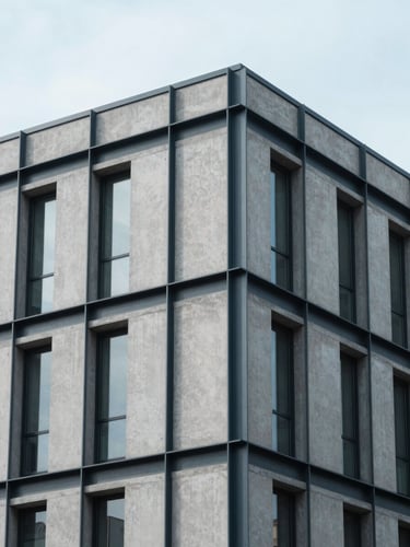 Architectural detail of a modern concrete and steel financial building in Caldwell, soft overcast daylight, clean lines, 35mm