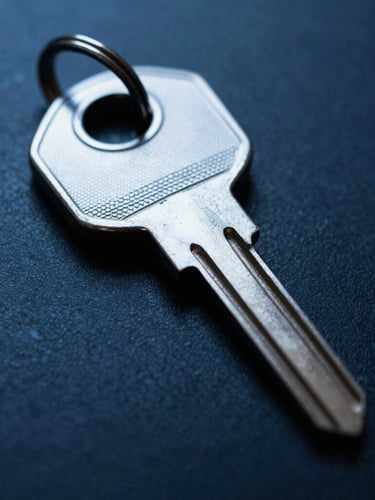 Extreme close-up of a physical security key, cold steel, sharp focus, low-key lighting with blue accents, 35mm.