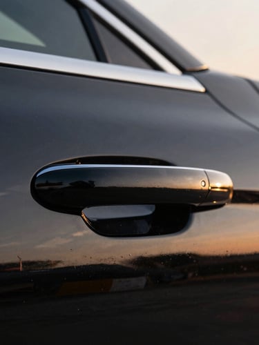 Close-up of a pristine luxury car door handle and polished black paint, golden hour light, sharp focus, 35mm automotive photography